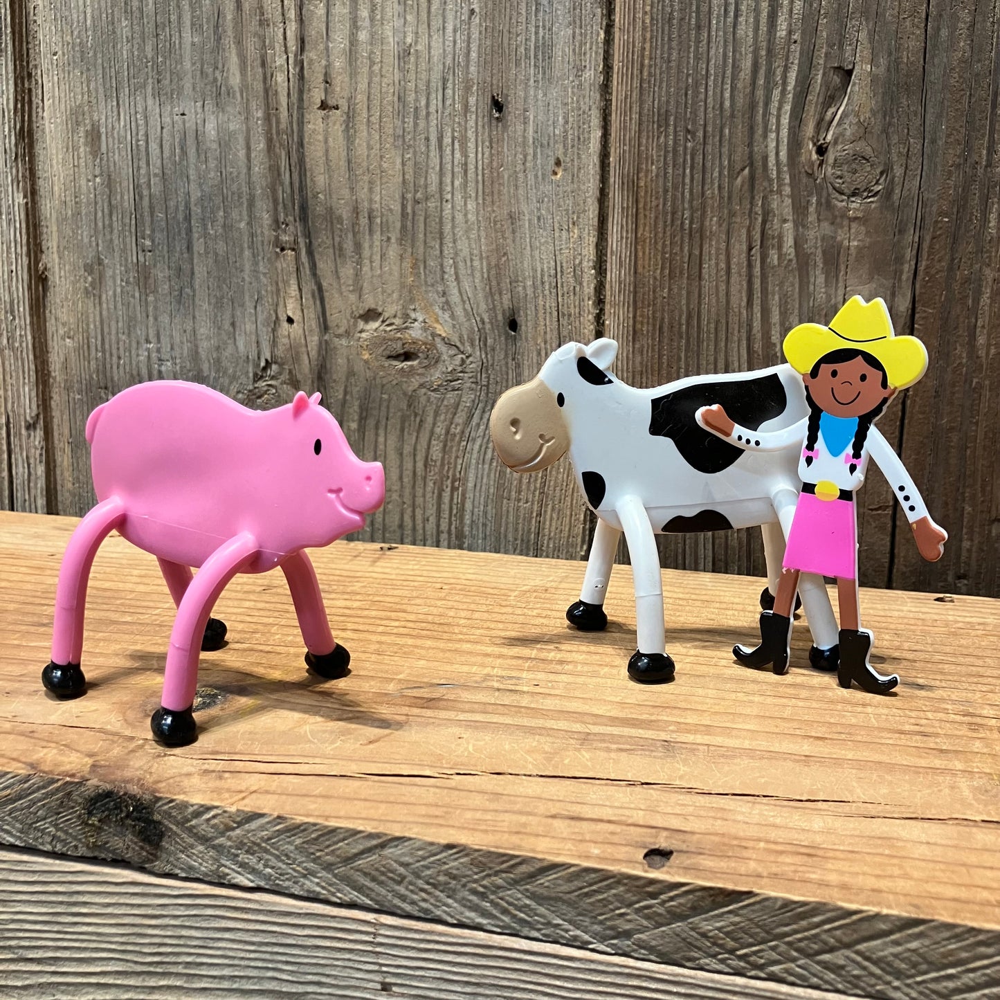 bendable farm animal toys with pink cowgirl (sold separately), pig, and cow