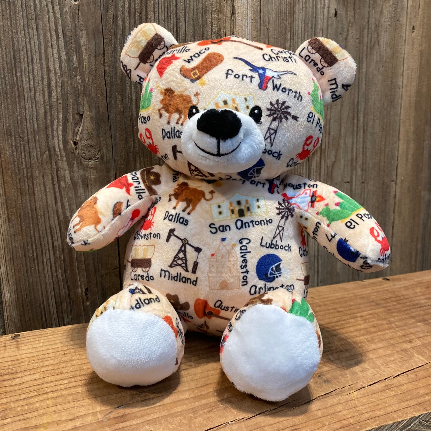 10-inch plush bear with names and icons of Texas cities printed on the fabric