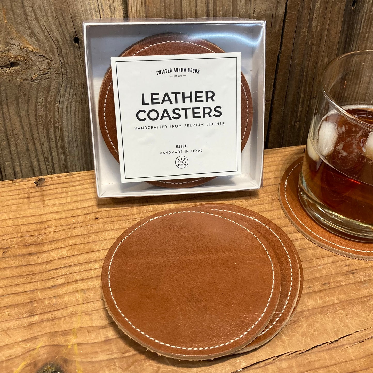 Close-up of saddle-colored leather coaster with Texas outline and "Home" design, part of the handmade leather coaster set.