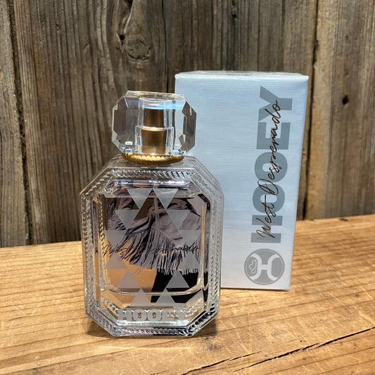 Hooey West Desperado women’s perfume bottle with matching box displayed on a rustic wood background.