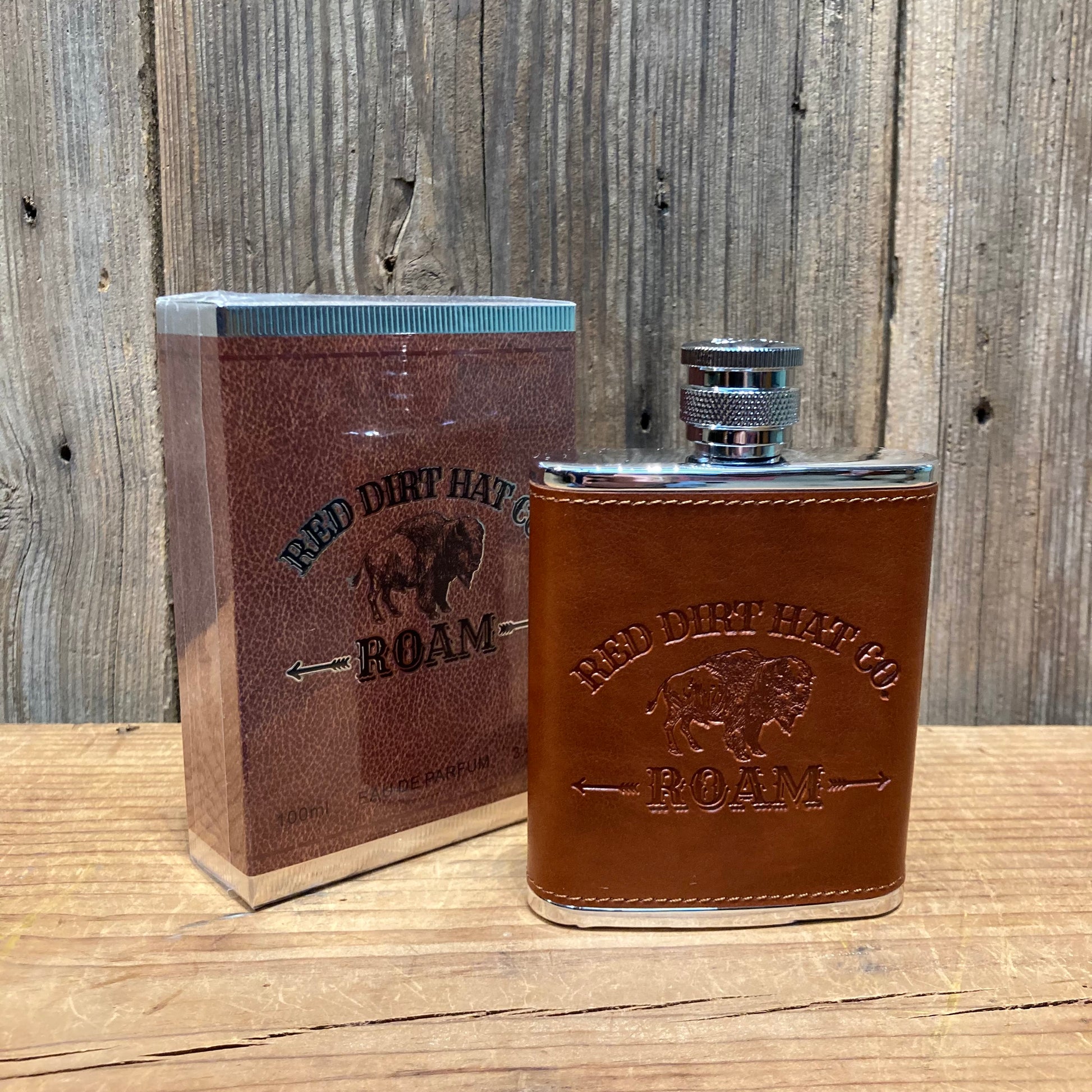 Roam cologne by RDHC 
Has a fresh, clean, masculine scent with leather tones and an underlying hint of cedarwood. 

scent notes:
top - red grapefruit, Italian lemon, saffron spice
mid - orange flower, aromatic lavender, sage leaf, cool geranium
dry - rich amber, sensual tonka, warm woods

made in USA. 3.4 fl. oz. in a flask bottle wrapped in red leather stamped with Red Dirt Hat Co. Logo