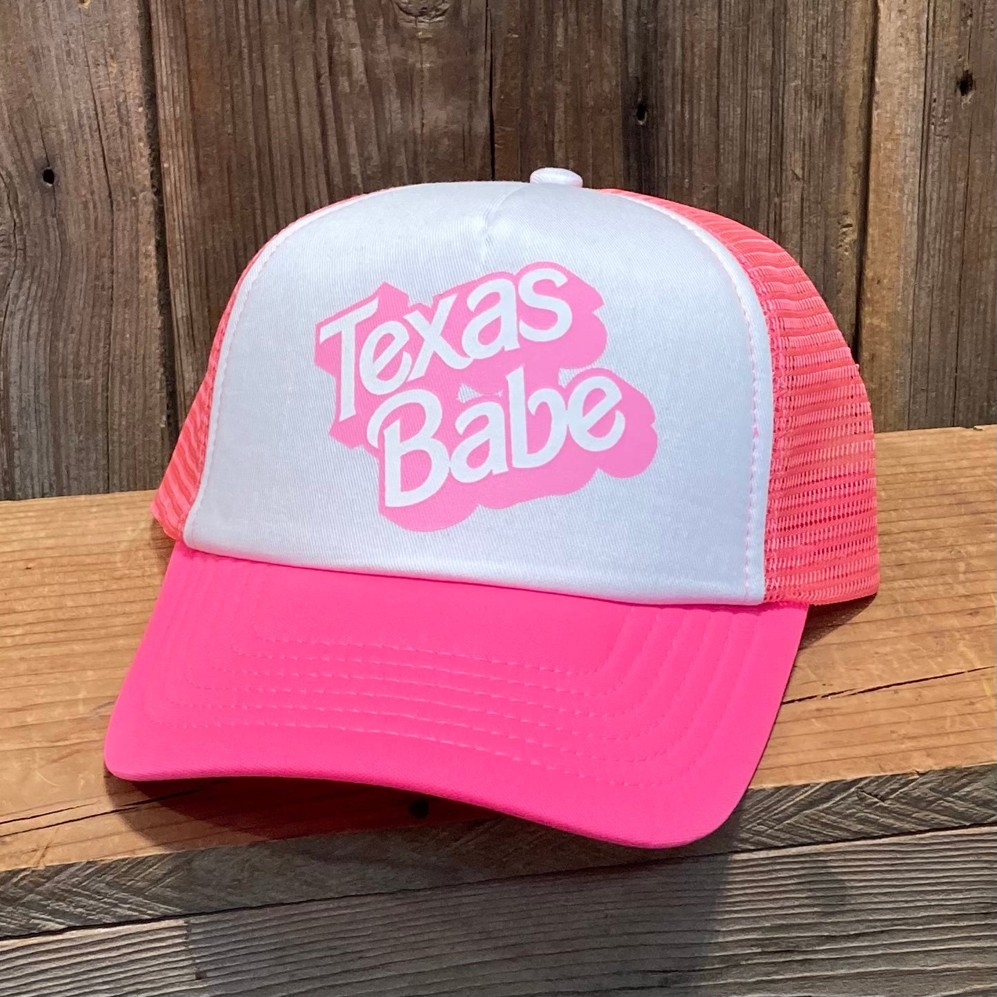 inspired by the hit movie, Barbie, add a little pink to your wardrobe - Texas style!

Pink & White Foam Trucker Hat with Snapback with the writing Texas Babe screen printed in pink.