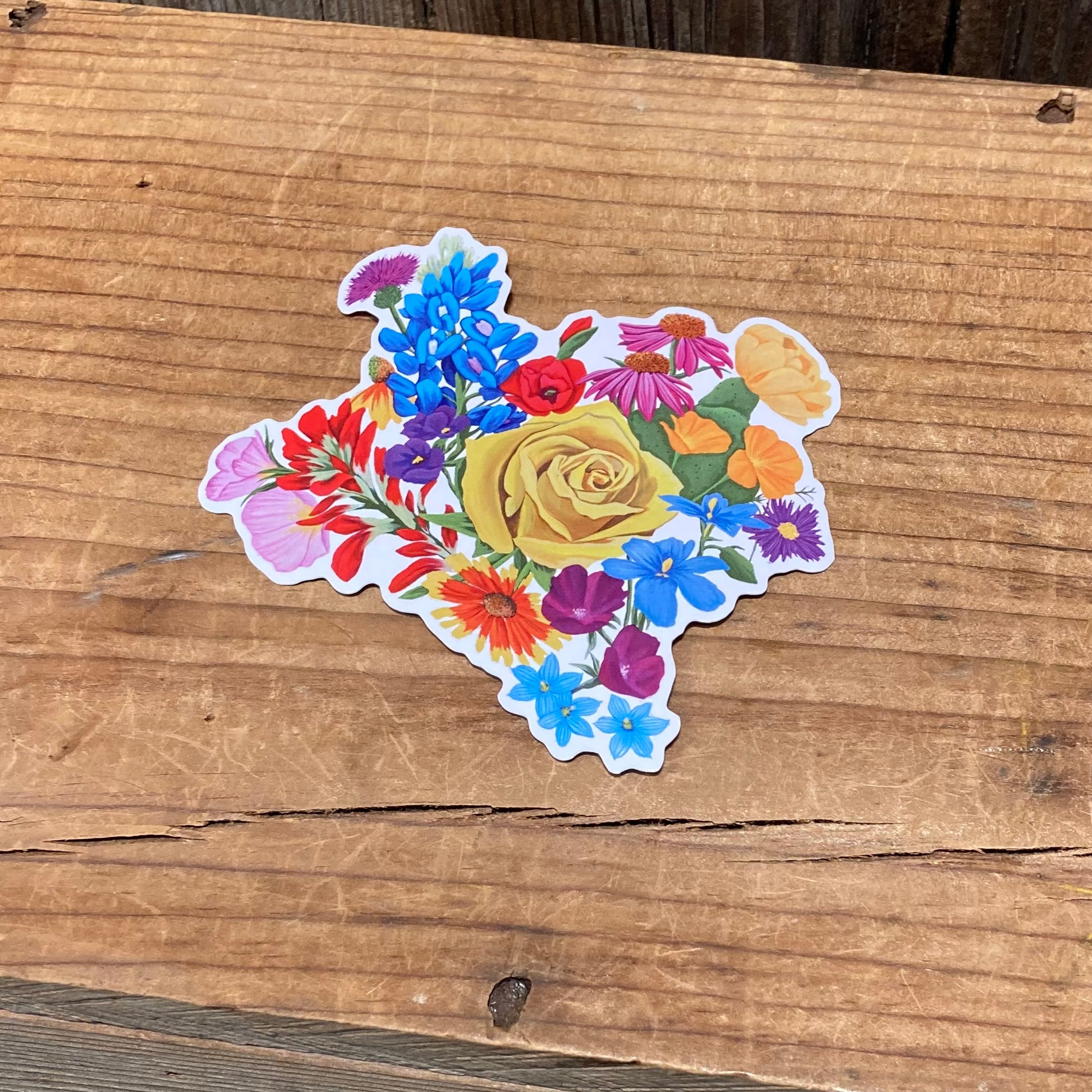 Texas Floral vinyl sticker on a wooden surface with Texas-shaped floral design.
