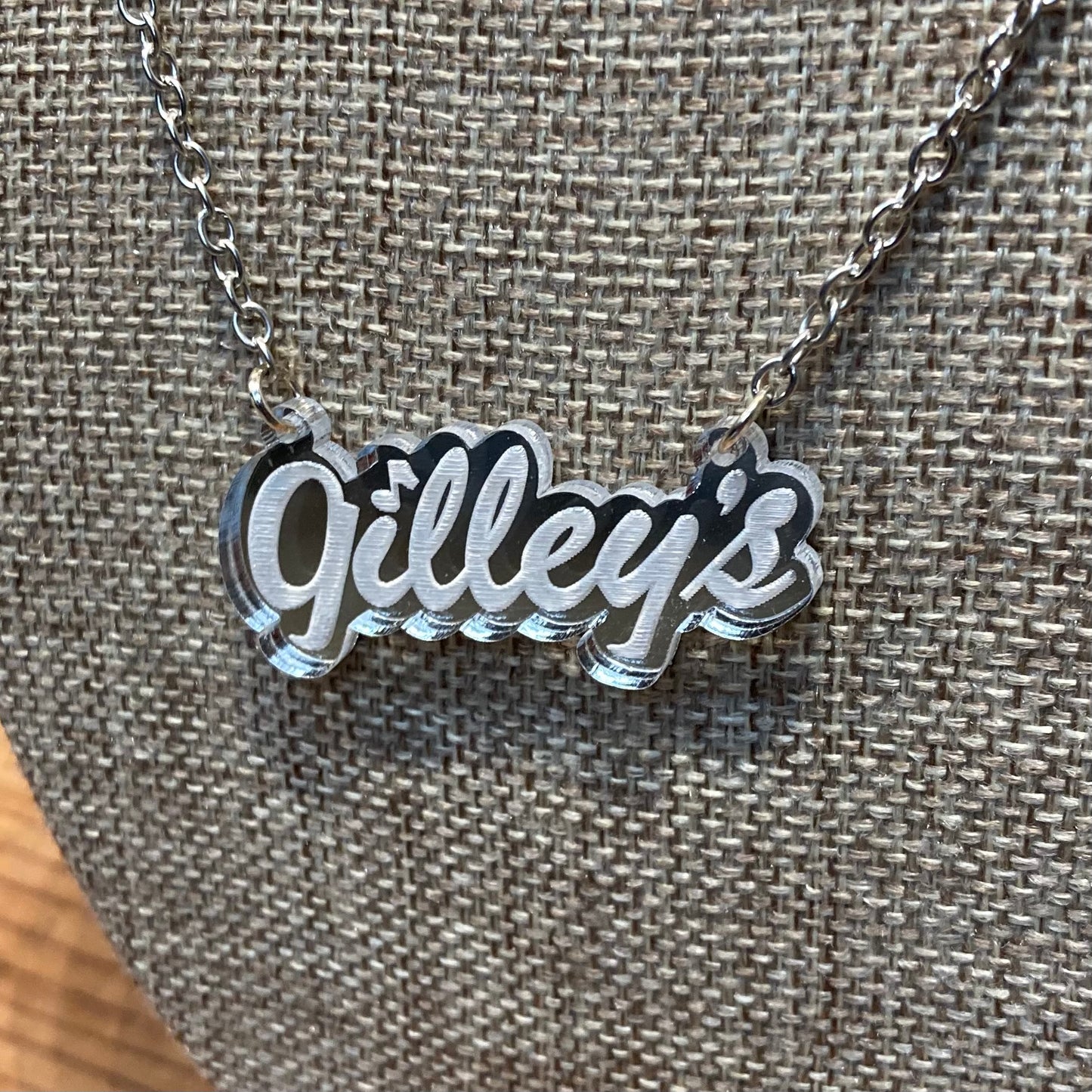 Close-up of the Gilley’s Logo Necklace featuring a mirrored acrylic pendant on a 16” chain. Officially licensed and handcrafted in Texas.