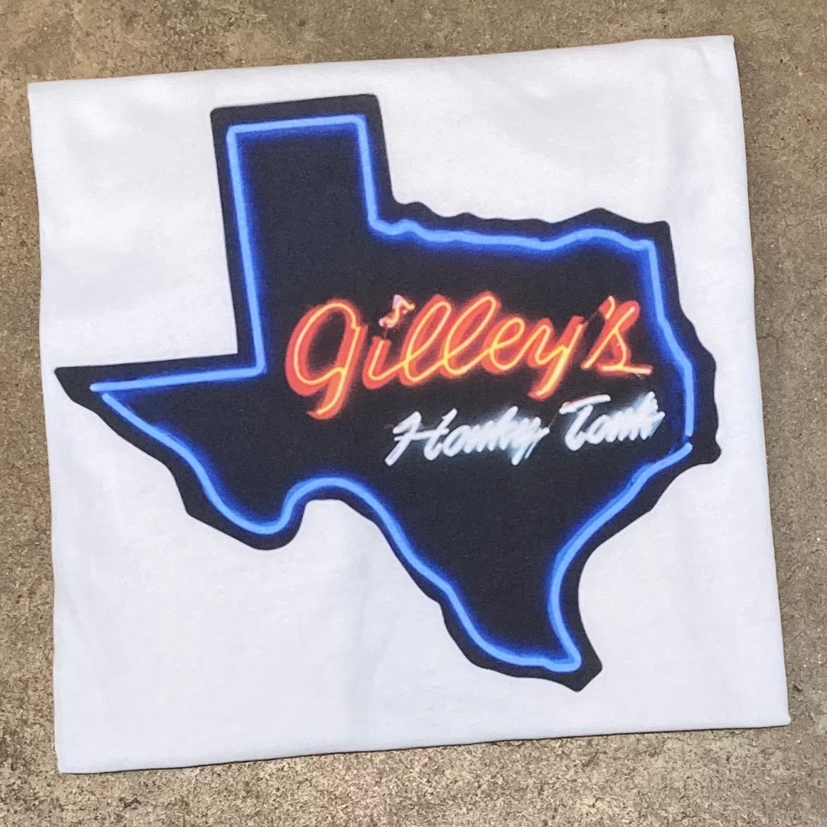 Gilley's neon sign design t-shirt.

officially licensed Gilley's merchandise, printed in Texas.

Unisex. White tshirt with Gilley's neon sign screenprint.