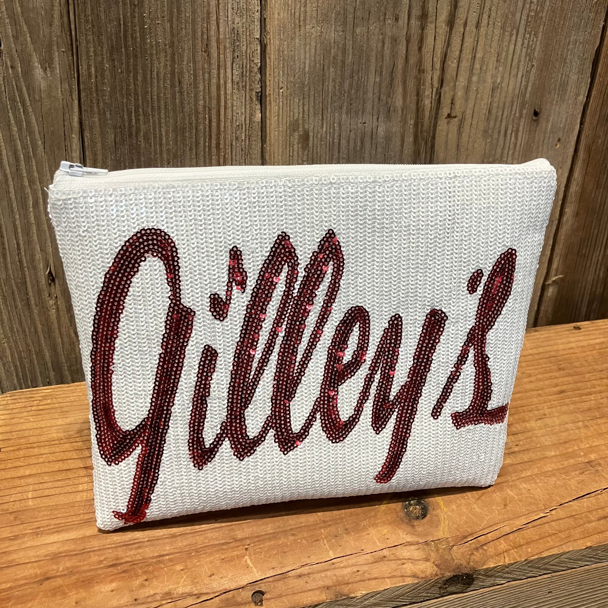 Gilley’s Sequin Makeup Bag with a bold red sequin logo, perfect for keeping your essentials organized in style. A chic and practical accessory for any occasion.