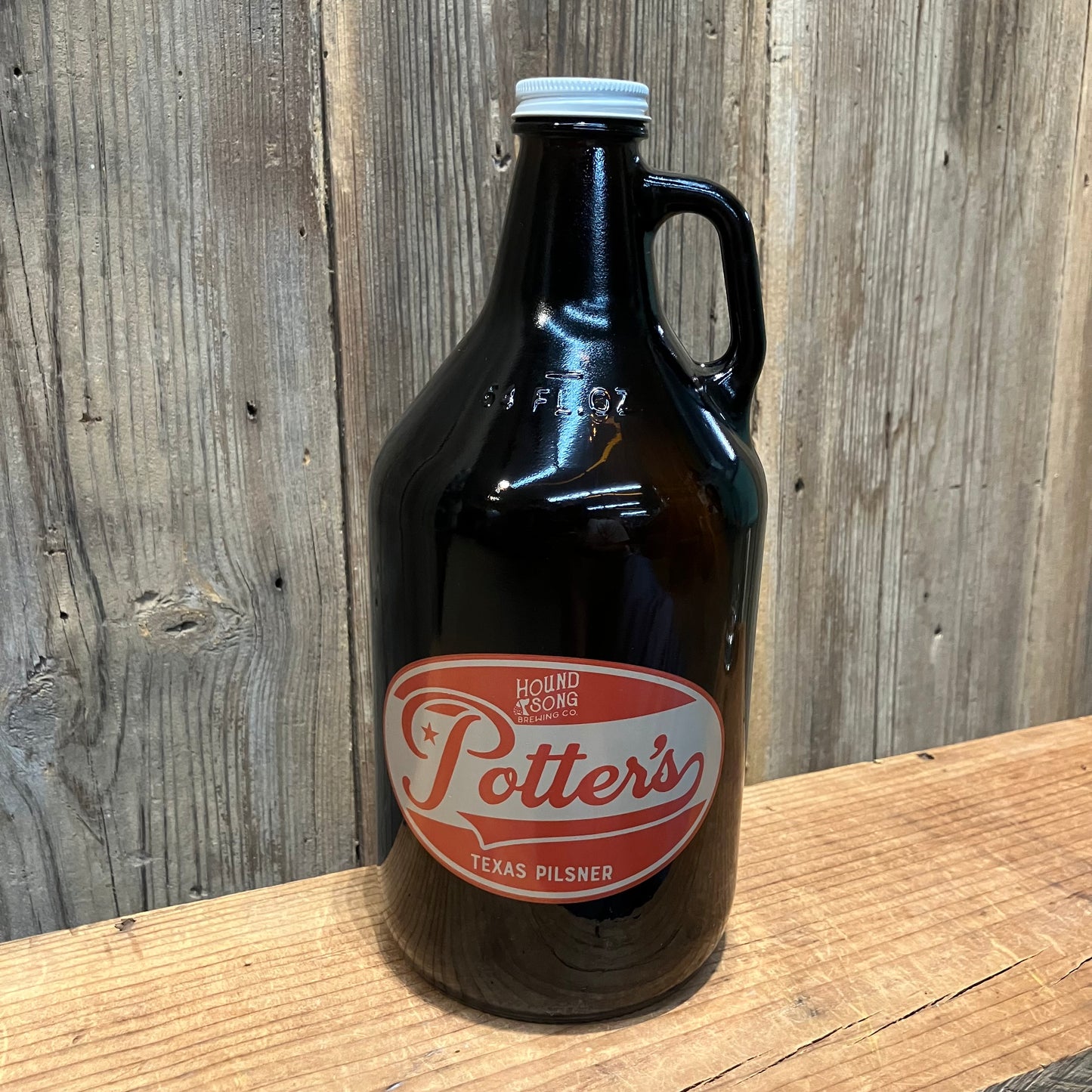 64 oz brown growler with Potter’s Pilsner red oval logo