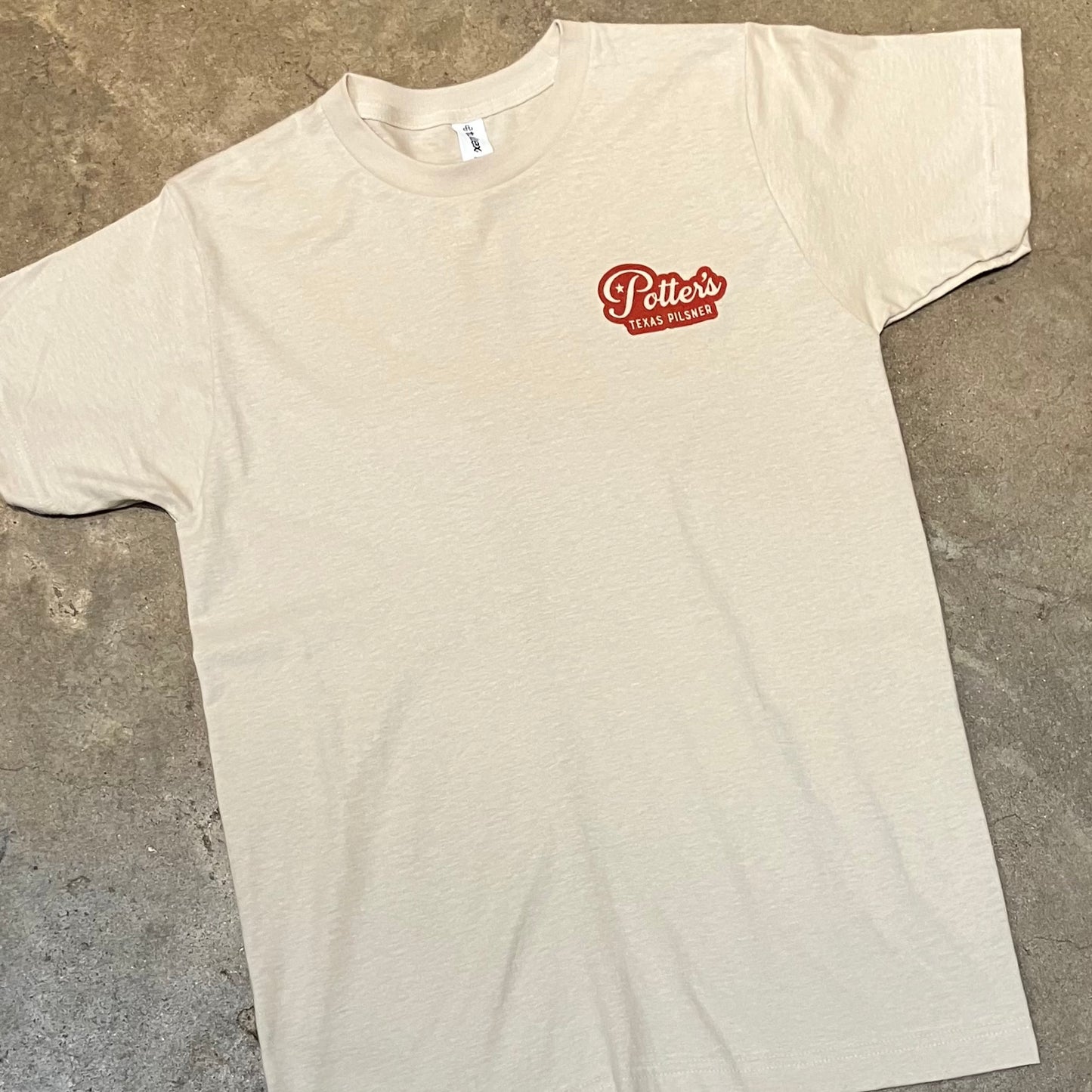 front of Potter’s Pilsner shirt showing small red logo on pocket area
