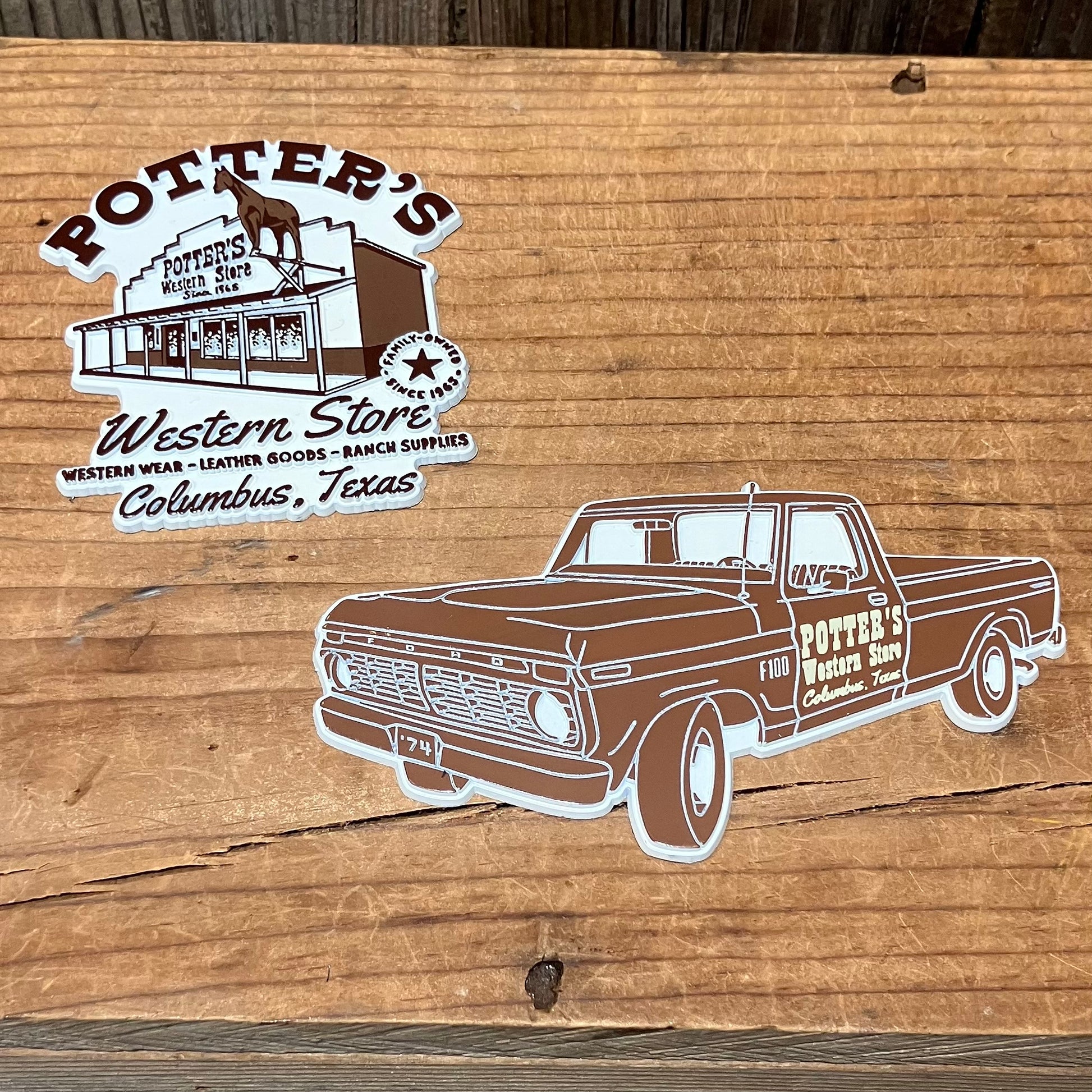 Magnet of Potter's Western Store and truck on a wooden surface