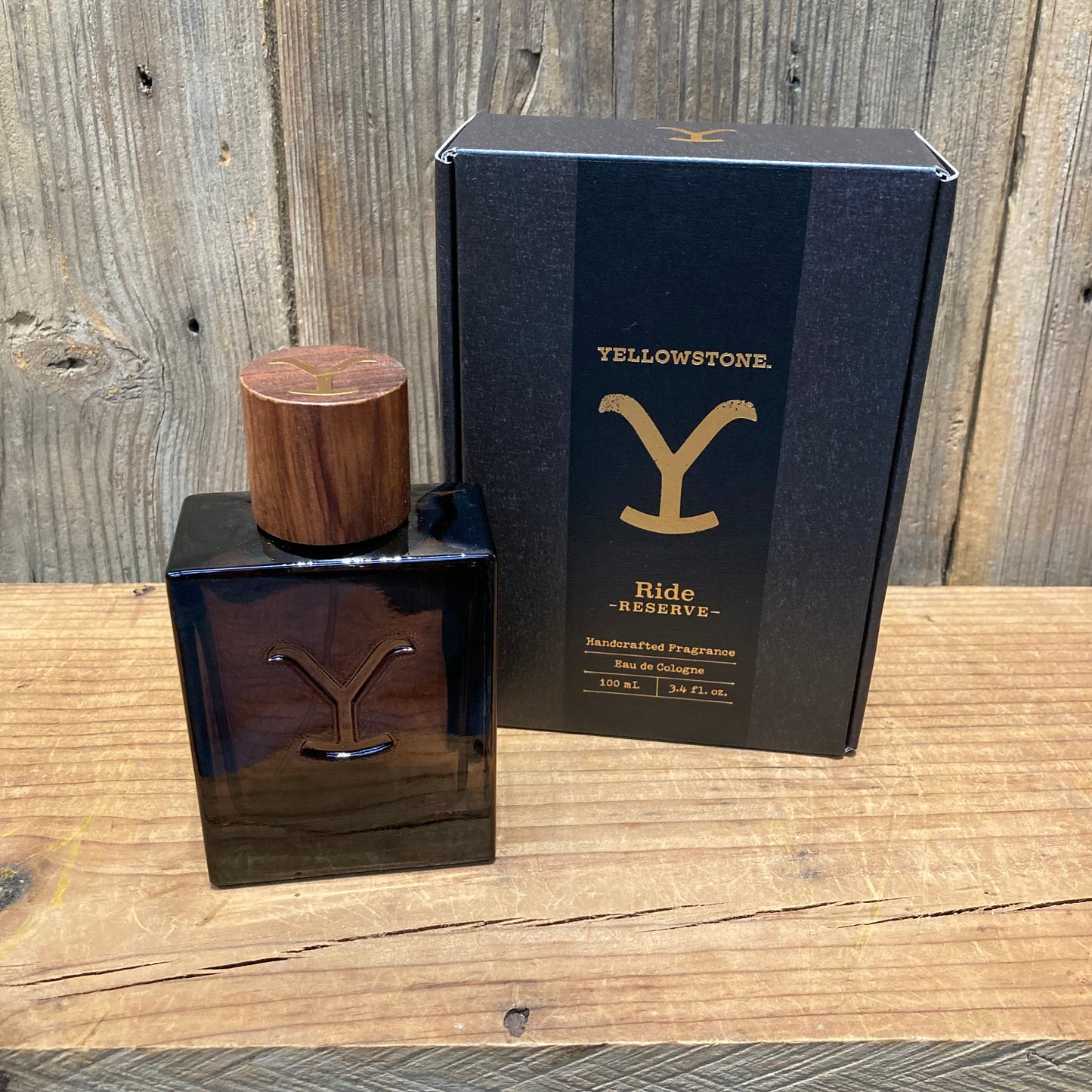 Yellowstone Ride Reserve Cologne with a sleek bottle and wood top, featuring notes of citrus, aged woods, and smokey vanilla. 3.4 fl. oz. size.